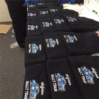 Selection of black wooly hats with embroidered logos